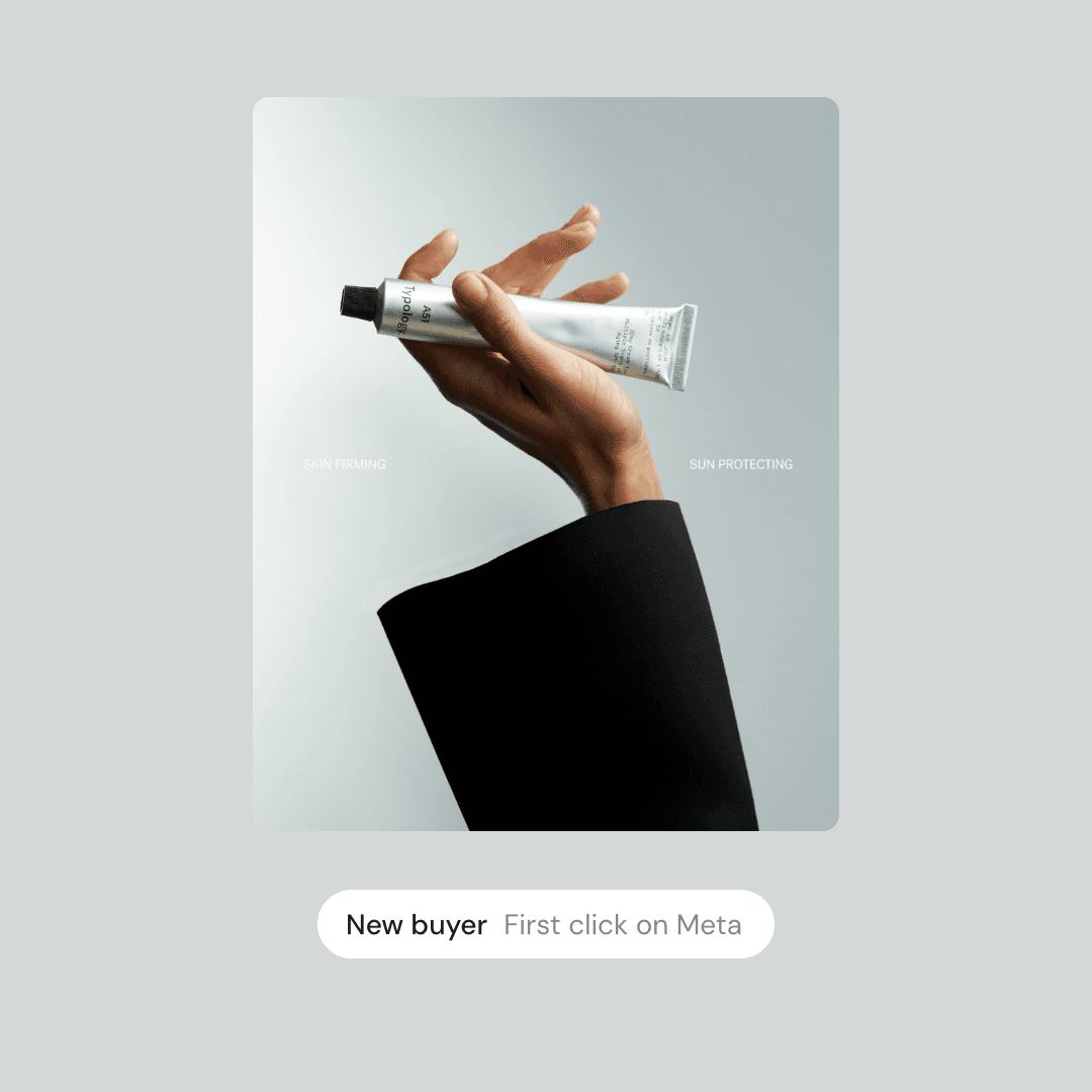 An ad showing a hand holding up a tube of sunscreen, tagged New buyer, first click on Meta.